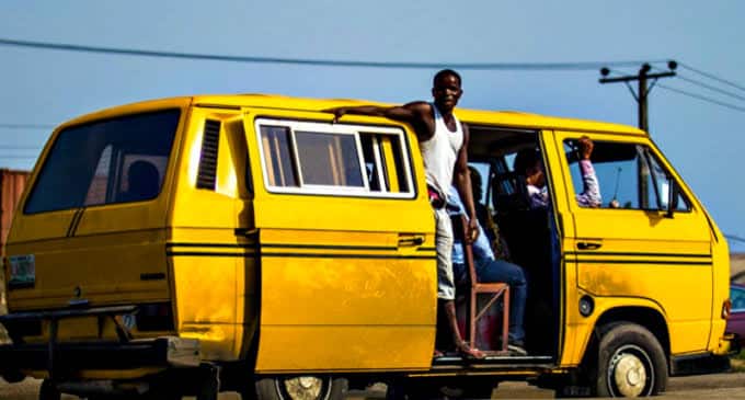 Bus conductor inspecting currency