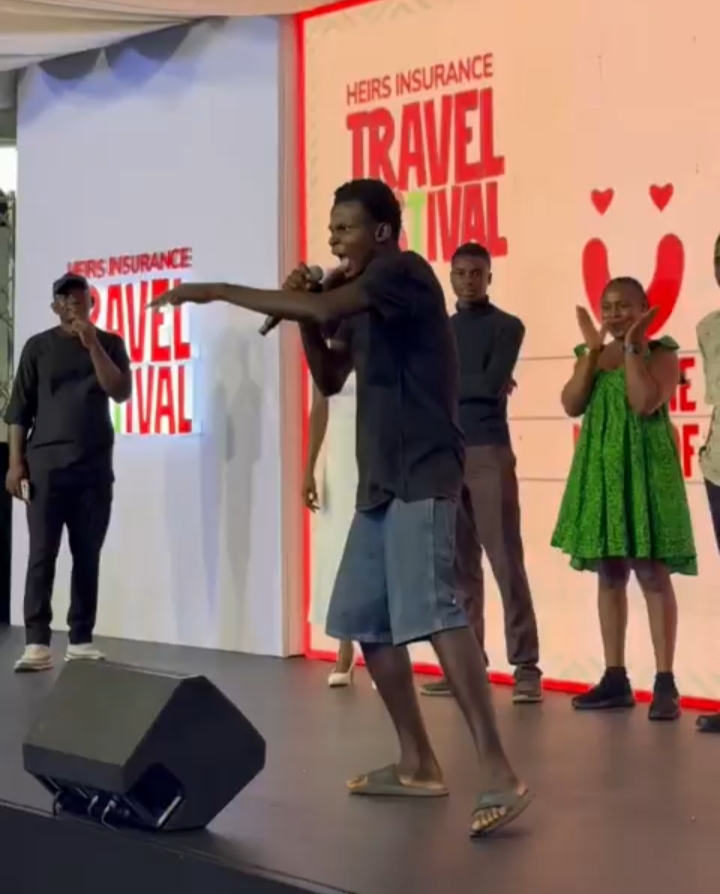 Man performing on stage at Heirs Insurance event